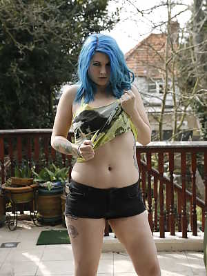 Thick amateur Emma J Black sports blue hair while stripping on a deck