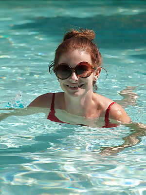 Big tit redhead amateur Essie Halladay having fun in a swimming pool