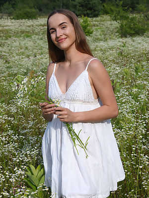 Eva Jolie charmingly undresses in the middle of the flower field and exposes