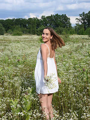 Eva Jolie charmingly undresses in the middle of the flower field and exposes