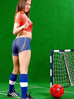 Sporty european babe Eve Mendes posing in body painted football uniform