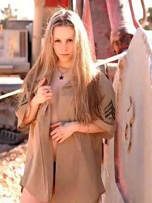 Sultry blonde Fiona Luv poses in the desert in army shirt bikini panty & heels