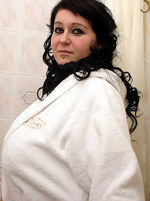 Dark-haired chick Gloria Gotta shows her giant tits while taking a bubble bath