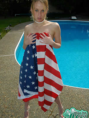 Teen amateur Lucky releases her naked body from an American flag by a pool