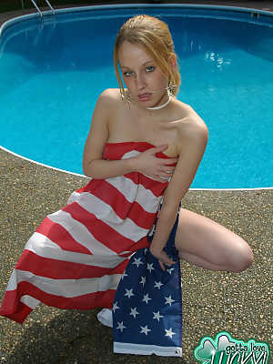 Teen amateur Lucky releases her naked body from an American flag by a pool