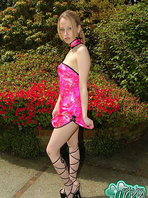 Young amateur Lucky partially removes a pretty dress near blooming bushes