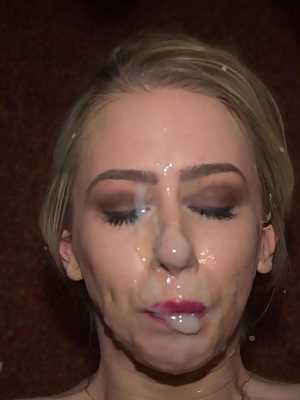 Busty blonde receives open mouth cumshots during a bukkake party