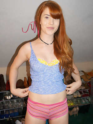 Cute nerdy redhead Gwen Stark poses in jeans and reveals her tiny teen tits