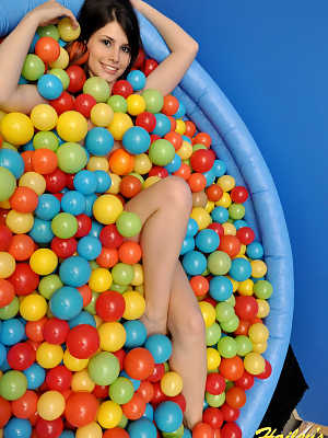 Cute teen Hailey immerses herself in a wading pool filed with balls