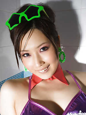 Asian babe Haruka Yagami lowering her fishnet pantyhose and panties