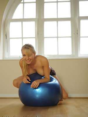 Athletic blond Hayley Marie Coppin strikes great nude poses on a medicine ball
