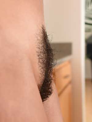 Sexy MILF Helena Price unveils her inviting hairy pussy in a hot kitchen strip