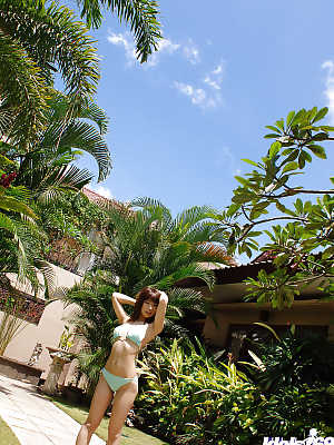 Cute asian babe Hikari Hino slipping off her bikini top outdoor