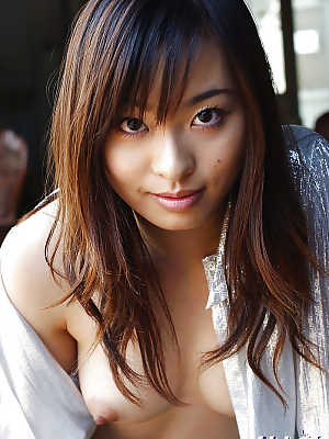 Petite asian babe Hikaru Koto taking off her shirt and posing topless