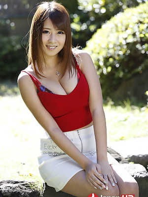 Sweet Asian girl Hitomi Kitagawa displays her nice boobs in the yard
