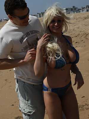 Blonde MILF Holly Brooks getting her big hooters juggled on the beach