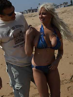 Blonde MILF Holly Brooks getting her big hooters juggled on the beach