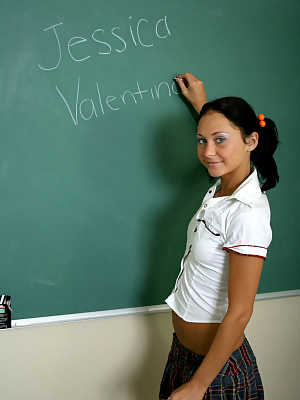 Pigtailed schoolgirl Jessica Valentino flashes her pussy in the classroom