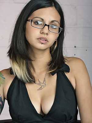 Glasses clad Holly D with big tits drops dress & sheer panties to pose naked