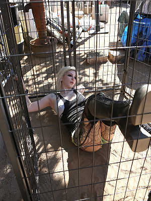 Caged tattooed American pornstar Indigo August breaks free for braless BBQ