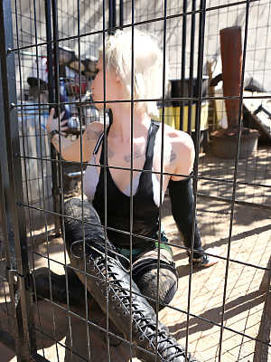 Caged tattooed American pornstar Indigo August breaks free for braless BBQ