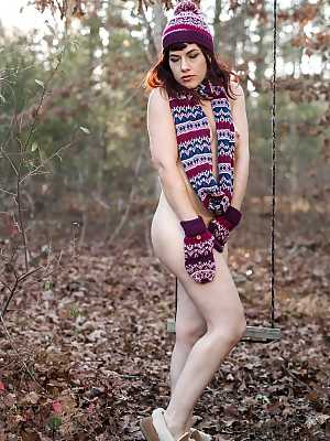 Leggy solo girl Ingrid Mouth posing naked in forest in toque and boots