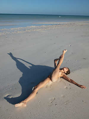 Flexible Colombian teen Irene Rouse	posing butt naked on a sandy beach