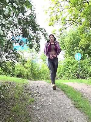 Solo girl Isabel Dark pulls down leather pants to pee on a dirt road