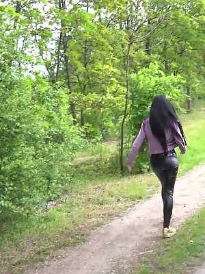 Solo girl Isabel Dark pulls down leather pants to pee on a dirt road