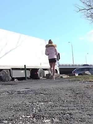 White girl Isabel Dark takes a piss on a gravel lot wear big rigs park
