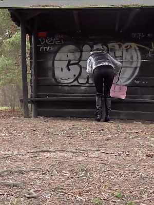 Isabel Dark relieves herself underneath a shelter