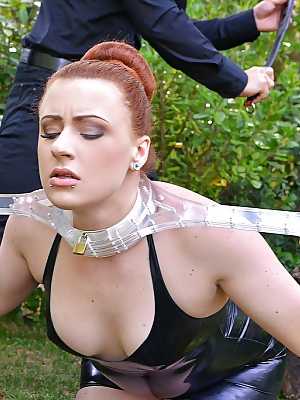 European redhead Isabel Dean takes part in an BDSM scene outdoor