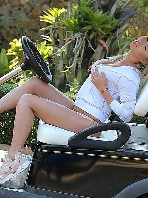 Blond teen Isabella D exposes her hot body before a finger fuck on a golf cart