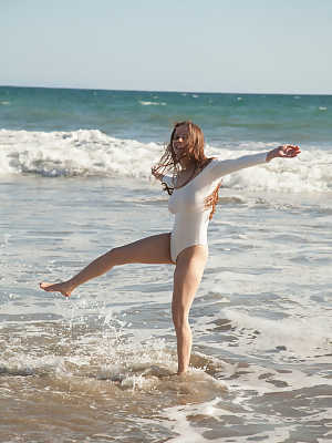 Teen in a white bodysuit Avri Gaines teases with her big boobs on the beach