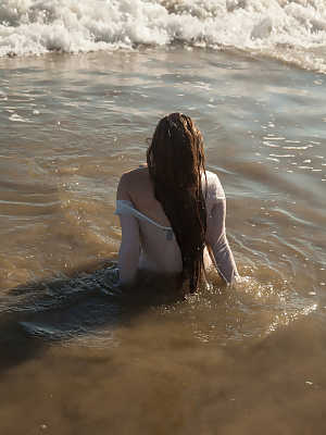 Sexy girlfriend Avri Gaines gets wet as she poses in her bodysuit on the beach