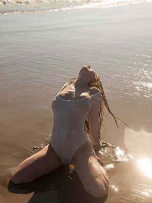 Sexy girlfriend Avri Gaines gets wet as she poses in her bodysuit on the beach