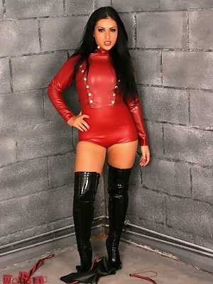 Dark haired domme Jasmine Jones wields a bull whip in latex duds and boots