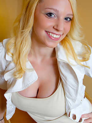 Smiley blonde amateur Jeannine Hansen removes her top to flaunt enormous tits