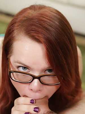 Redhead teen in glasses Jennifer gives a big cock blowjob