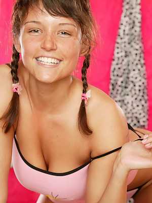 Smiley teen Jenny E showcases her great boobs before toying herself