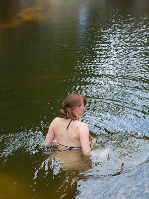 Hot redhead amateur disrobes at the lake to go skinny dipping & sunbathe nude