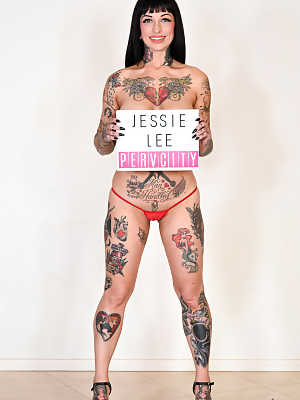 Kinky pornstar Jessie Lee strips her tiny bikini & exposes her hot inked body