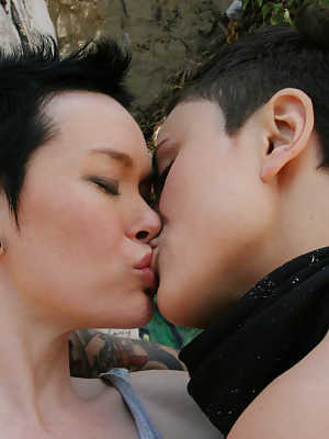 Short haired dykes Syd Blakovich & Jiz Lee kiss and toy twats while outdoors