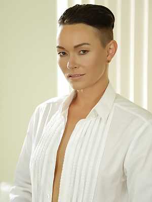 Androgynous short haired model Jiz Lee posing in her male outfit