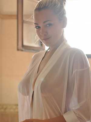 Beautiful blonde chick Jodie Gasson pulls on a see thru blouse in the morning