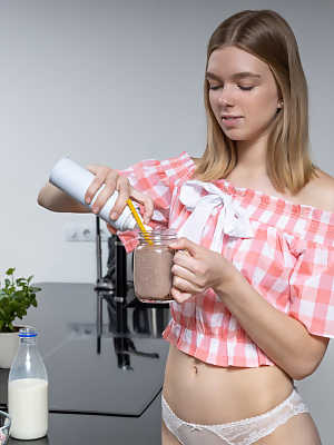 Young looking girl Junia makes her nude debut on a kitchen counter